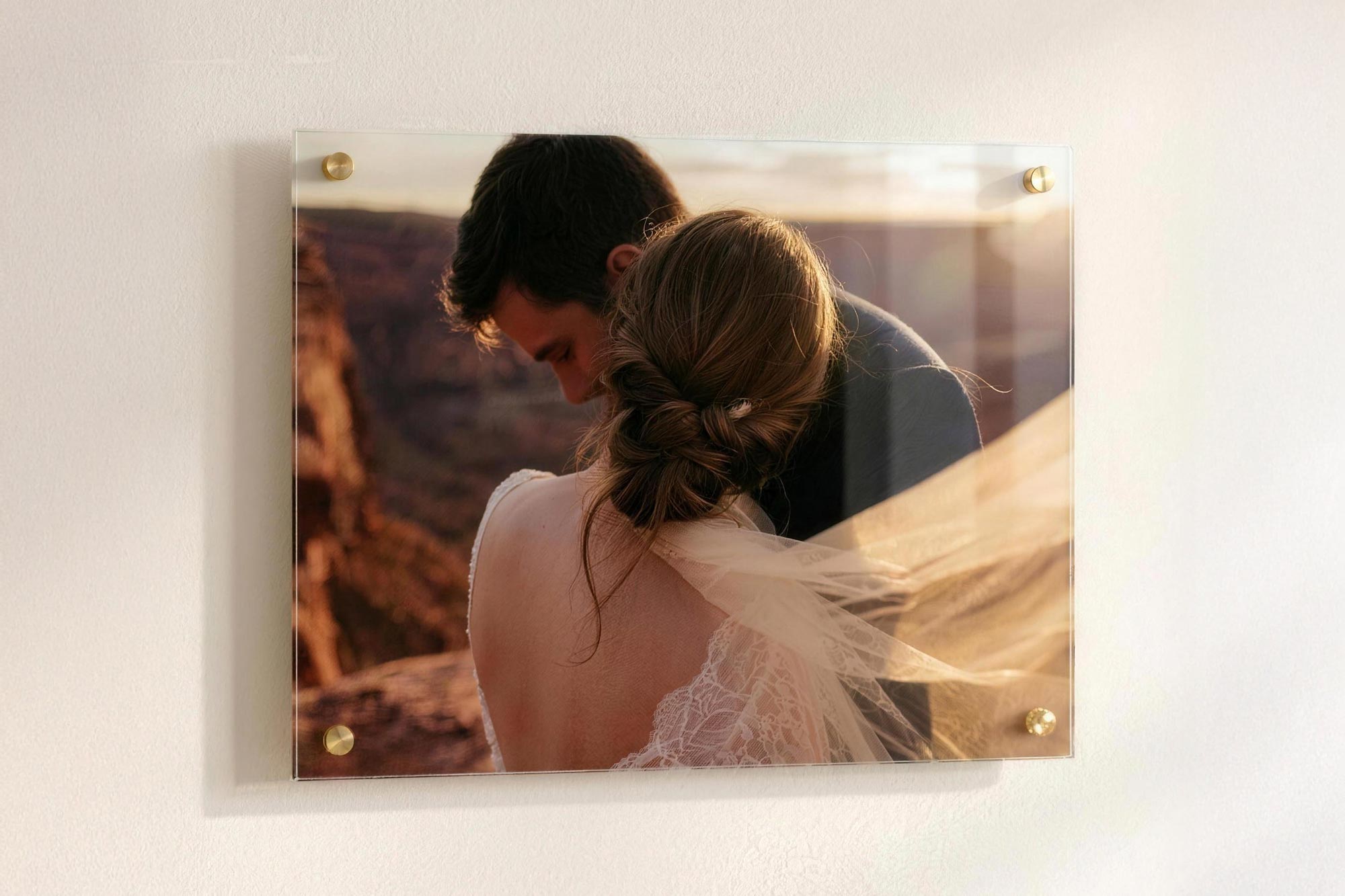 Acrylic print mounted on a wall with four gold standoffs, floating with a soft shadow behind it